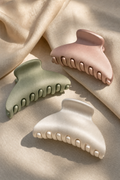 Three Lullacurl silk matte claw clips in cream, blush, sage